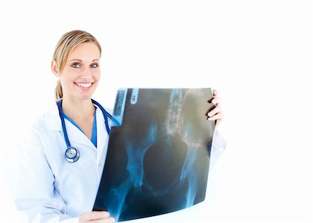 Ambitious female doctor looking at a x-ray against white background Stock Photo - Budget Royalty-Free & Subscription, Code: 400-04708476