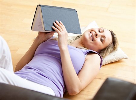 simsearch:400-04206778,k - Radiant woman lying on the floor reading a book at home Foto de stock - Super Valor sin royalties y Suscripción, Código: 400-04708508