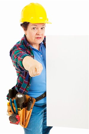 plumber (female) - Serious female construction worker pointing to you and holding a sign. Stock Photo - Budget Royalty-Free & Subscription, Code: 400-04709655