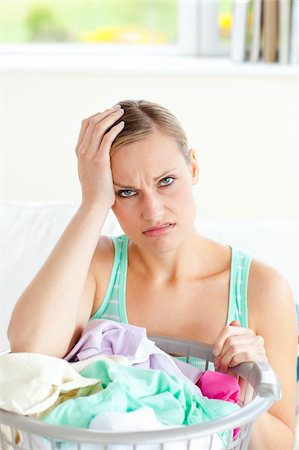 simsearch:400-08693600,k - Exhausted young woman doing the laundry at home Stock Photo - Budget Royalty-Free & Subscription, Code: 400-04709964