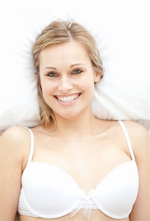 simsearch:400-05729462,k - Smiling woman in underwear lying on bed at home Stock Photo - Budget Royalty-Free & Subscription, Code: 400-04700521