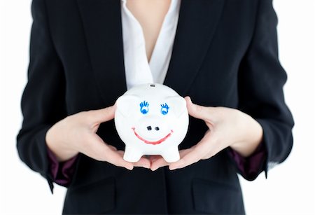 simsearch:400-04184165,k - Close-up of a businesswoman holding a piggybank against white background Stock Photo - Budget Royalty-Free & Subscription, Code: 400-04702399