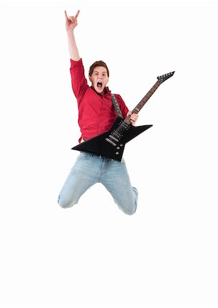 picture of a passionate guitarist making a jump and a rock and roll hand gesture Stock Photo - Budget Royalty-Free & Subscription, Code: 400-04702947