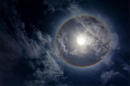 simsearch:400-04265415,k - Sun with circular rainbow, clouds and blue sky Stock Photo - Budget Royalty-Free & Subscription, Code: 400-04703059
