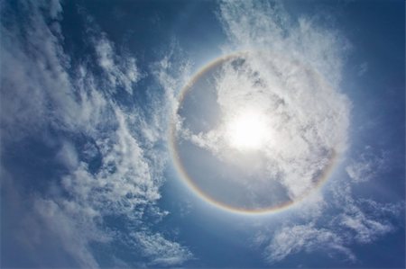 simsearch:400-04265415,k - Sun with circular rainbow, clouds and blue sky Stock Photo - Budget Royalty-Free & Subscription, Code: 400-04703060