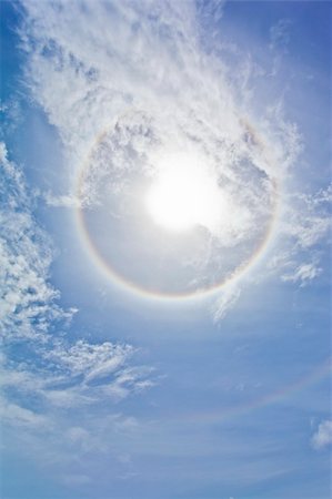simsearch:400-04265415,k - Sun with circular rainbow, clouds and blue sky Stock Photo - Budget Royalty-Free & Subscription, Code: 400-04703061