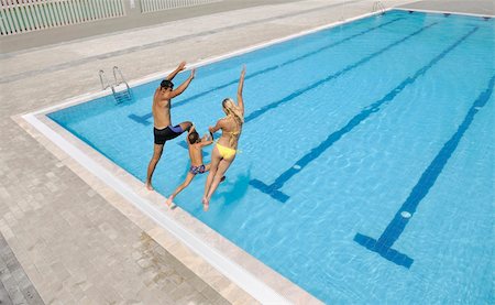 simsearch:400-05309800,k - happy young family have fun on swimming pool  at summer vacation running and jumping in the pool Stock Photo - Budget Royalty-Free & Subscription, Code: 400-04714174