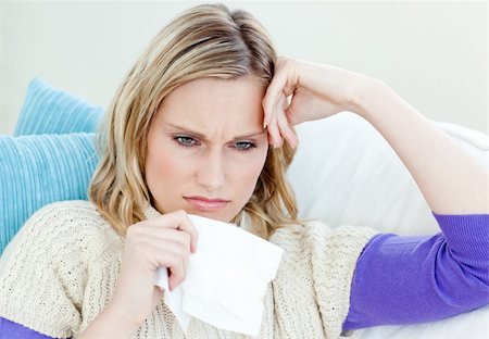 feeble - Diseased woman lying on a sofa with tissues against a white background Foto de stock - Super Valor sin royalties y Suscripción, Código: 400-04715315