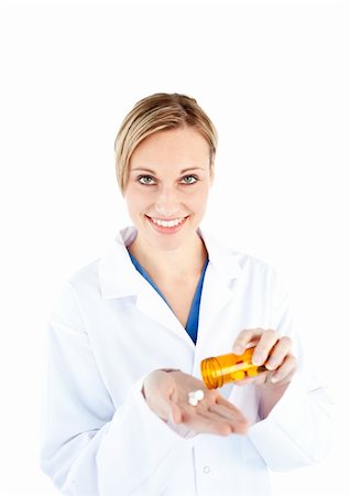simsearch:6109-06005907,k - Charming young doctor holding pills smiling at the camera against a white background Stock Photo - Budget Royalty-Free & Subscription, Code: 400-04715334