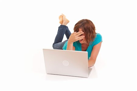 Young woman casually laying on floor with laptop Stock Photo - Budget Royalty-Free & Subscription, Code: 400-04715576