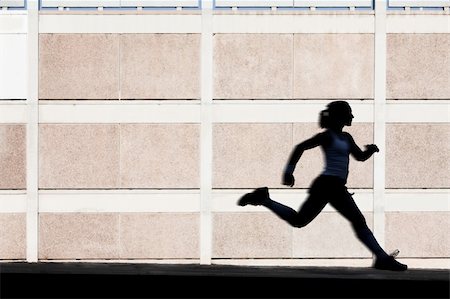 Woman in the shadows of building runs for exercise. Stock Photo - Budget Royalty-Free & Subscription, Code: 400-04715959