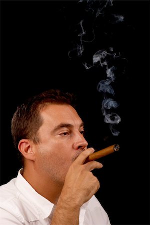 simsearch:400-05207678,k - Guy enjoying a freshly lit cuban cigar Stock Photo - Budget Royalty-Free & Subscription, Code: 400-04717648