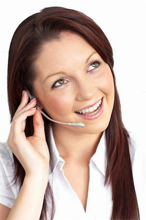 simsearch:400-05287143,k - Charming young businesswoman wearing earpiece against a white background Stock Photo - Budget Royalty-Free & Subscription, Code: 400-04719963