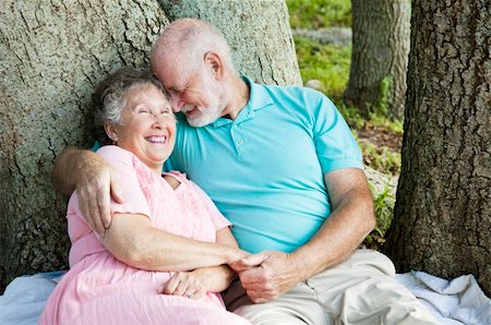 simsearch:400-04208630,k - Senior couple in love.  He's whispering something funny in her ear. Stock Photo - Budget Royalty-Free & Subscription, Code: 400-04710135