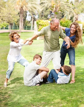 simsearch:400-07426233,k - Family members holding back grandfather and having fun Stock Photo - Budget Royalty-Free & Subscription, Code: 400-04710224