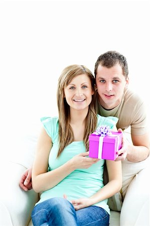 simsearch:400-04195864,k - Young boyfriend giving a present to his glowing girlfriend against white background Stock Photo - Budget Royalty-Free & Subscription, Code: 400-04710339