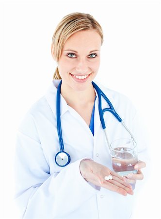 simsearch:6109-06005907,k - Pretty female doctor holding pills and water against white background Stock Photo - Budget Royalty-Free & Subscription, Code: 400-04712396