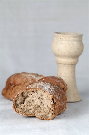 Loaf of bread and chalice with wine. Shallow dof, copy space Stock Photo - Budget Royalty-Free & Subscription, Code: 400-04712410