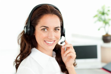 simsearch:400-05287143,k - Smiling woman looking at the camera wearing a headset working in a customer service Stock Photo - Budget Royalty-Free & Subscription, Code: 400-04724094