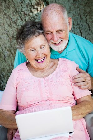 simsearch:400-04208630,k - Senior couple stays in touch with the grandchildren using a small netbook laptop computer. Stock Photo - Budget Royalty-Free & Subscription, Code: 400-04724920