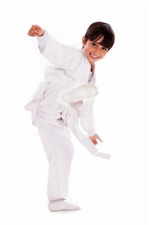 simsearch:400-04347301,k - Karate kid kicking over isolated white background Photographie de stock - Aubaine LD & Abonnement, Code: 400-04726873