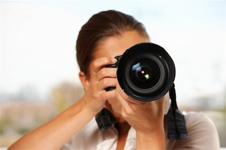 A young woman taking pictures over white background Stock Photo - Budget Royalty-Free & Subscription, Code: 400-04723931