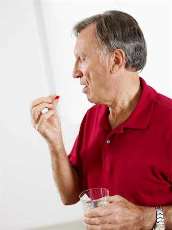 simsearch:6108-05867295,k - Senior man taking medicine. Vertical shape, Side view, Copy space Stock Photo - Budget Royalty-Free & Subscription, Code: 400-04735078
