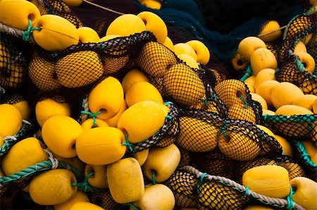 Closeup on fishing net with yellow floaters stored on fisher boat during the day Foto de stock - Super Valor sin royalties y Suscripción, Código: 400-04739464