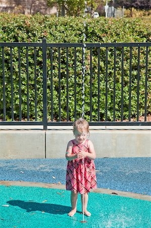 Cute little European toddler girl having fun with water at the playground in park Stock Photo - Budget Royalty-Free & Subscription, Code: 400-04730296