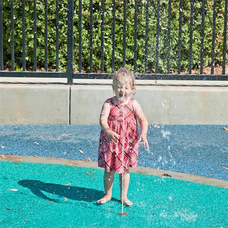 Cute little European toddler girl having fun with water at the playground in park Stock Photo - Budget Royalty-Free & Subscription, Code: 400-04731037