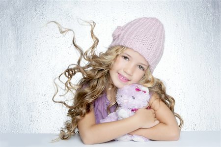 winter fashion cap little girl hug teddy bear smiling silver background Stock Photo - Budget Royalty-Free & Subscription, Code: 400-04731579