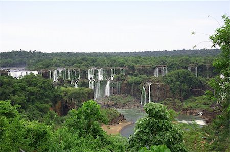 parana river - The Iguassu (or Iguazu) Falls is one of the largest masses of fresh water on the planet and divides, in South America, Brazil, Paraguay and Argentina. The waterfall system consists of 275 falls along 2.7 kilometres (1.67 miles) of the Iguazu River. Some of the individual falls are up to 82 metres (269 feet) in height, though the majority are about 64 metres (210 feet). Stock Photo - Budget Royalty-Free & Subscription, Code: 400-04731922