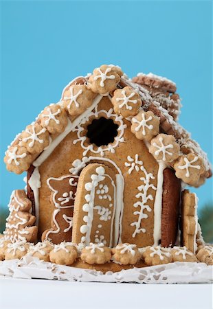 Christmas gingerbread house on blue background. Shallow dof Stock Photo - Budget Royalty-Free & Subscription, Code: 400-04733789
