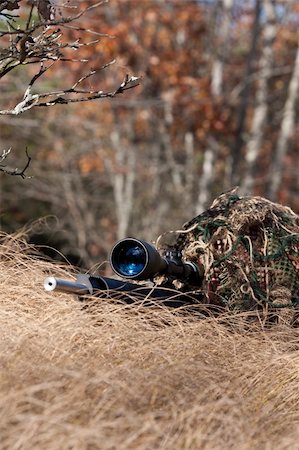 simsearch:400-04072400,k - sniper laying on the ground covered in a ghille suite tall grass and trees in the background Stock Photo - Budget Royalty-Free & Subscription, Code: 400-04744622