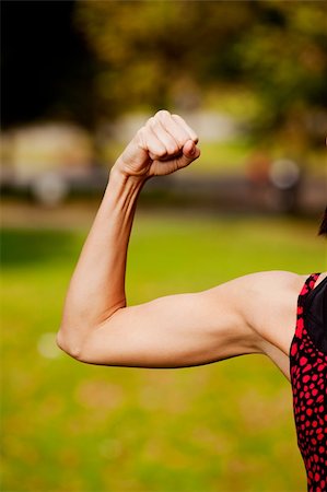 A female flexing her bicep muscle Stock Photo - Budget Royalty-Free & Subscription, Code: 400-04745093