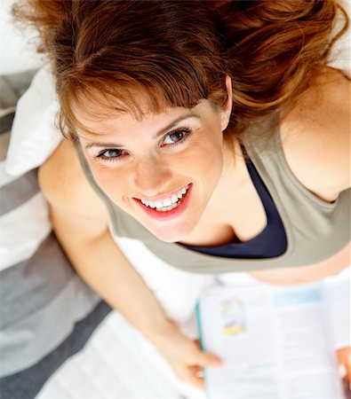 simsearch:400-04875116,k - Smiling beautiful pregnant woman sitting on sofa at home with magazine. Stock Photo - Budget Royalty-Free & Subscription, Code: 400-04747898