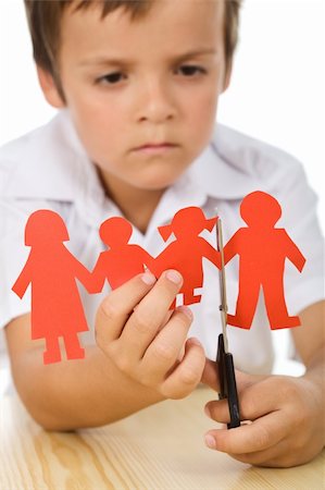 Sad kid cutting his paper people family - divorce concept, closeup Stock Photo - Budget Royalty-Free & Subscription, Code: 400-04740138