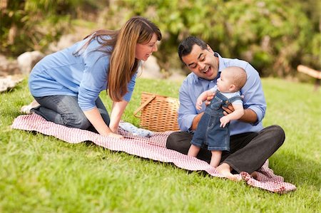 picnic family laugh - Happy Mixed Race Family Having a Picnic and Playing In The Park. Stock Photo - Budget Royalty-Free & Subscription, Code: 400-04743688