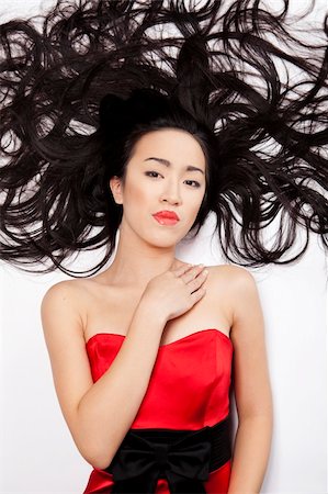 simsearch:400-04754019,k - beautiful Chinese woman lying down on the floor with long hair Stock Photo - Budget Royalty-Free & Subscription, Code: 400-04754020