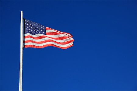 simsearch:400-06086537,k - An American flag waving against a blue sky in the breeze Stock Photo - Budget Royalty-Free & Subscription, Code: 400-04755017