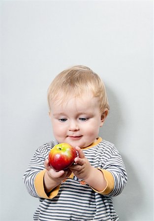 simsearch:400-04594888,k - Charming baby with apple on a grey background Stock Photo - Budget Royalty-Free & Subscription, Code: 400-04756382