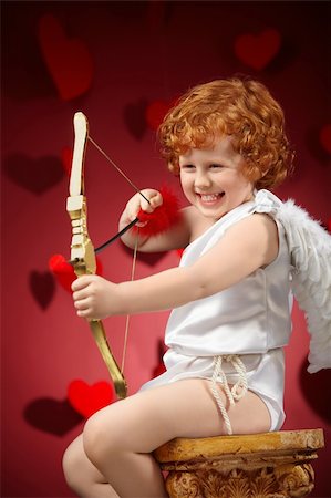 Laughing little boy in an image of the cupid does a shot Stock Photo - Budget Royalty-Free & Subscription, Code: 400-04756926