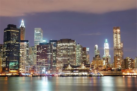 simsearch:400-07424733,k - New York City Manhattan skyline with office skyscrapers building in at dusk illuminated with lights at night over Hudson River Stock Photo - Budget Royalty-Free & Subscription, Code: 400-04758320