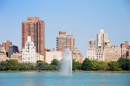 New York City Central Park fountain and urban Manhattan skyline with skyscrapers and trees lake reflection with blue sky and white cloud. Stock Photo - Budget Royalty-Free & Subscription, Code: 400-04758343