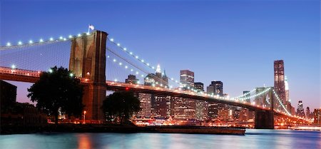 simsearch:400-07424733,k - New York City Brooklyn Bridge and Manhattan skyline panorama view with skyscrapers over Hudson River illuminated with lights at dusk after sunset. Stock Photo - Budget Royalty-Free & Subscription, Code: 400-04758450