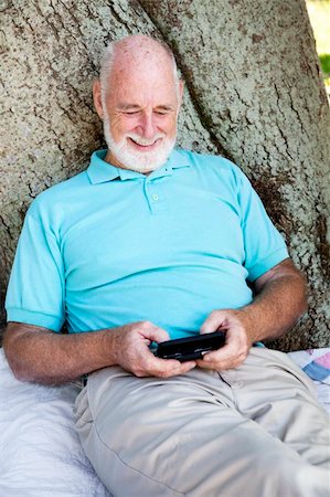 phone one person adult smile elderly - Senior man text messaging on his new smart phone. Stock Photo - Budget Royalty-Free & Subscription, Code: 400-04750175
