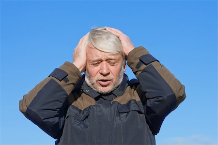 Portrait of mature desperate man with grey hair on blue sky of the background. Stock Photo - Budget Royalty-Free & Subscription, Code: 400-04765143