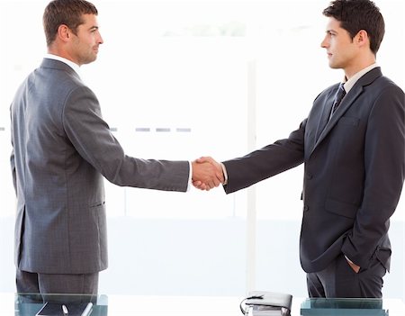 simsearch:400-04333648,k - Serious businessmen shaking their hands after a meeting at the office Stock Photo - Budget Royalty-Free & Subscription, Code: 400-04769433