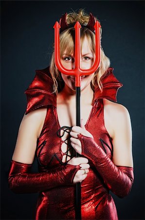 Red devil woman with trident on black background Stock Photo - Budget Royalty-Free & Subscription, Code: 400-04760865