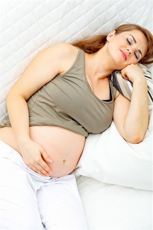 simsearch:400-04875116,k - Beautiful pregnant female sleeping on sofa at home. Stock Photo - Budget Royalty-Free & Subscription, Code: 400-04762784